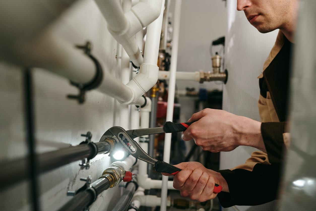 Plumbers maintaining commercial plumbing pipes in Daytona Beach
