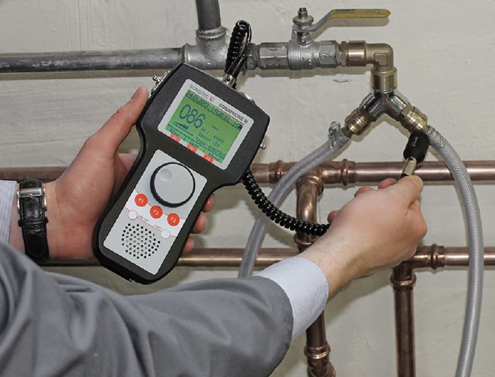 Plumber testing pipes with electronic leak detection equipment in Daytona Beach