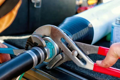 Technician tightening an industrial pipe connection in Daytona Beach