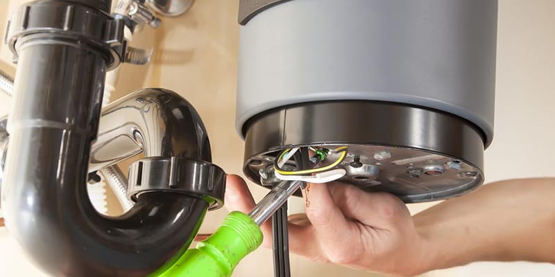 Technician repairing the heating element of a water heater in Daytona Beach