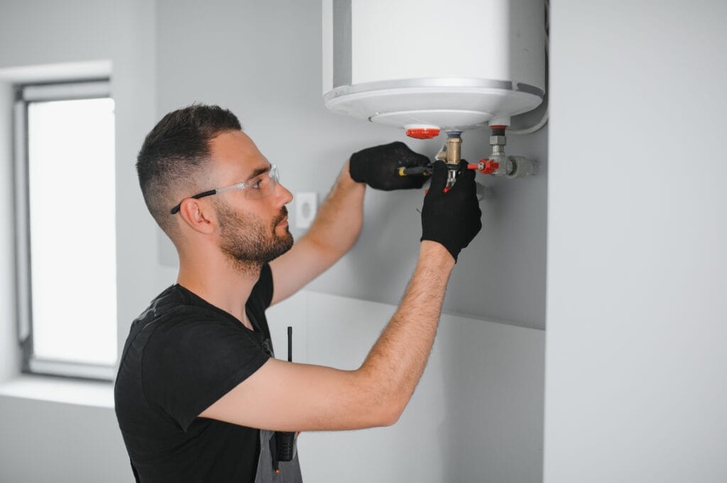 Technician performing water heater maintenance in Daytona Beach