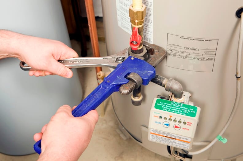 Plumber repairing a water heater valve in Daytona Beach